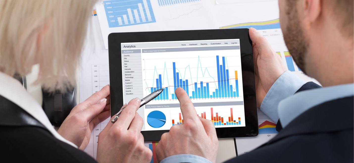 A financial advisor working with a client on a tablet device.